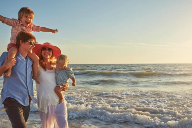 family of four in front of the ocean