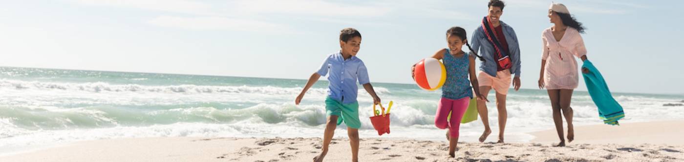 family on the beach with beach toys